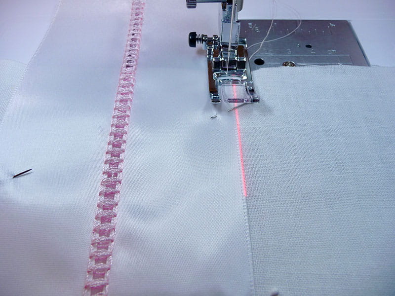 A picture containing sewing machine, sewing, sewing machine needle, appliance